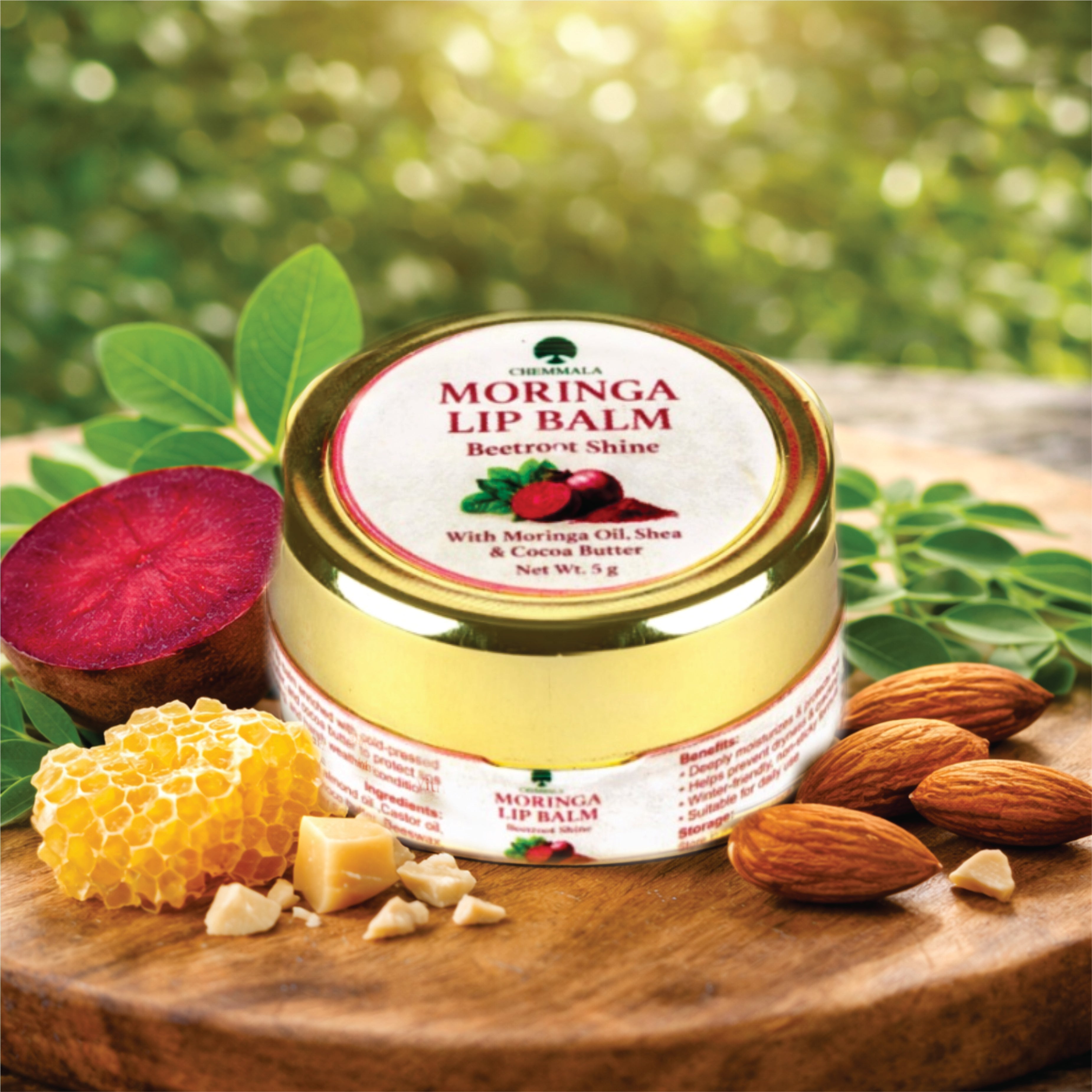 Chemmala Moringa Lip Balm Beetroot Shine in a natural lifestyle setting with moringa leaves, beetroot, almonds and beeswax highlighting herbal ingredients and lip care benefits