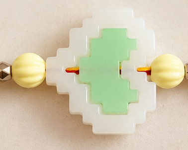 BeYoou.Bling Handcrafted Traditional Red & Yellow Thread Rakhi with Green & White Pixel Heart Centre Charm