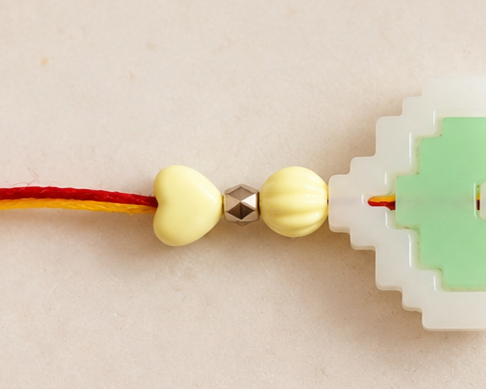 BeYoou.Bling Handcrafted Traditional Red & Yellow Thread Rakhi with Green & White Pixel Heart Centre Charm